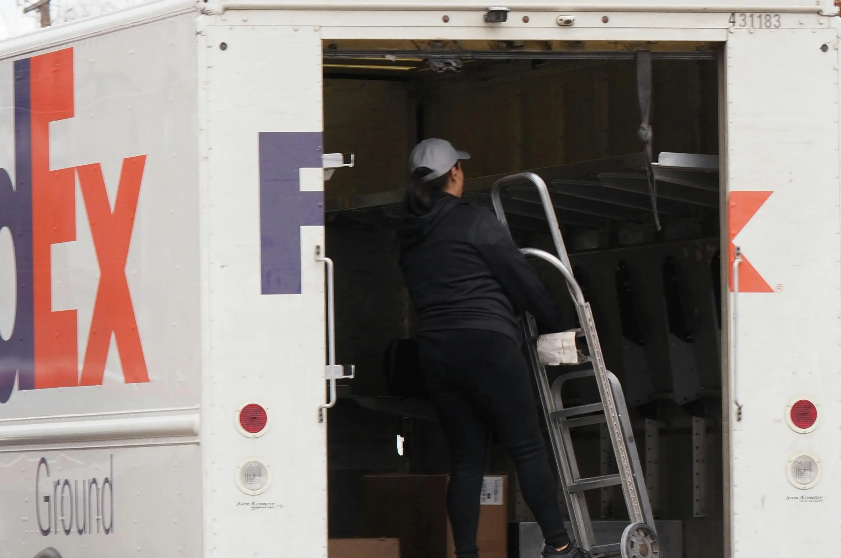 FedEx and UPS drivers performing pickup services